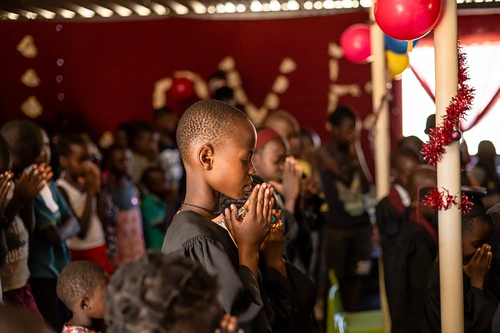 A girl prays as she completes The Greatest Journey