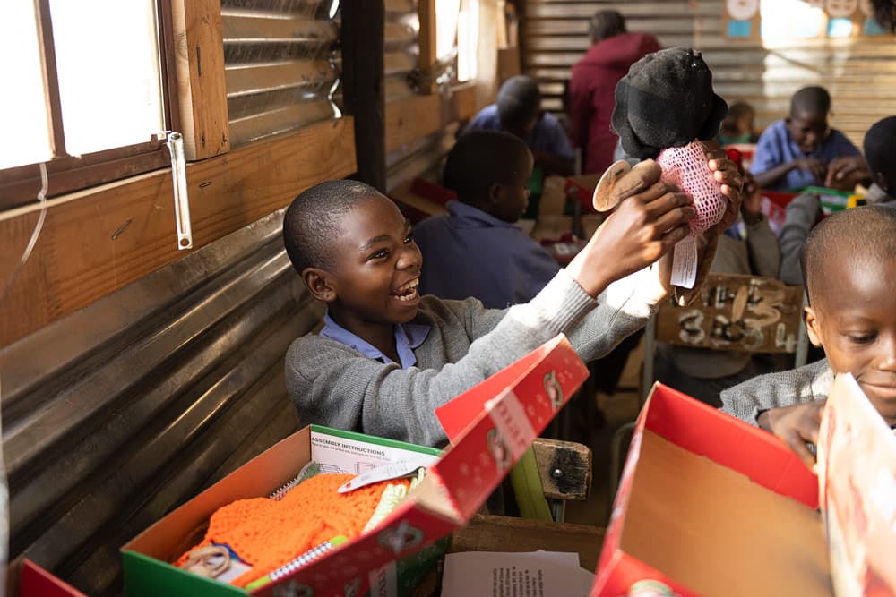 A deaf Himba girl enjoys her gifts